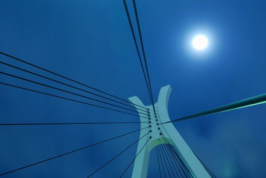 abstract suspension bridge elements on the night city sky with full moon
