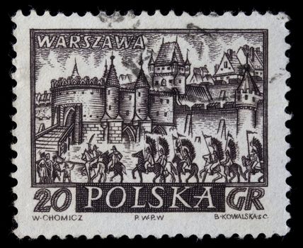 POLAND, circa 1960 - medieval town of Warsaw, Polish capitol,  with hussar winged cavalry on a vintage, canceled post stamp, dark brown engraving on white