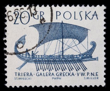 POLAND, circa 1960 - trireme, ancient Greek warship with three rows of oars, on a vintage canceled post stamp, blue drawing on white