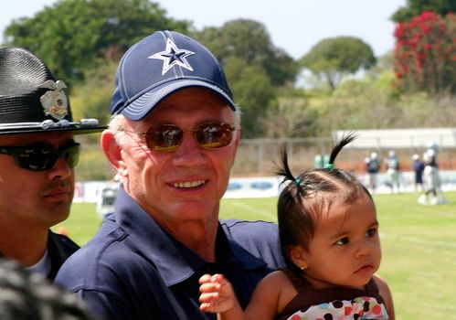 Jerry Jones the owner of the Dallas Cowboys is holding the baby of fan for a photo. The Dallas Cowboys coming every summer to Oxnard, Ca for their summer trainings camp. 7/29/08
