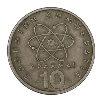 scientific model or symbol of atom schematically represented on old circulated 10 drachma Greek coin from 1976, isolated on white with clipping path