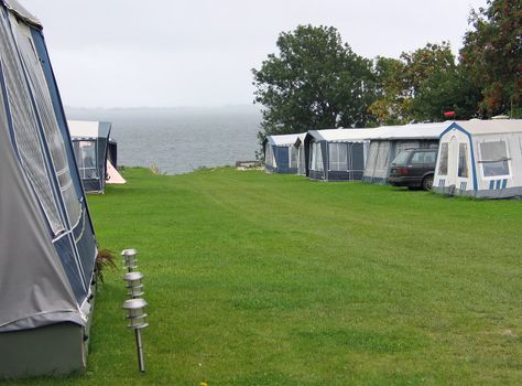 Caravans and campers park in a camping site by the ocean 