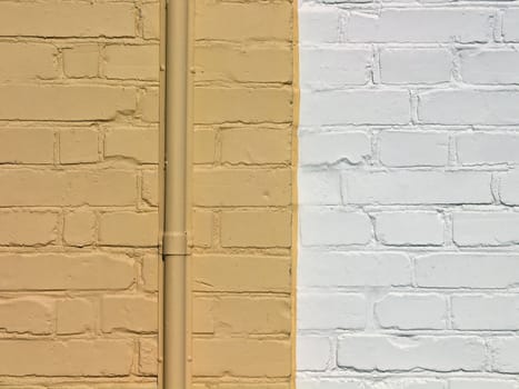 Wall made of painted yellow and white bricks