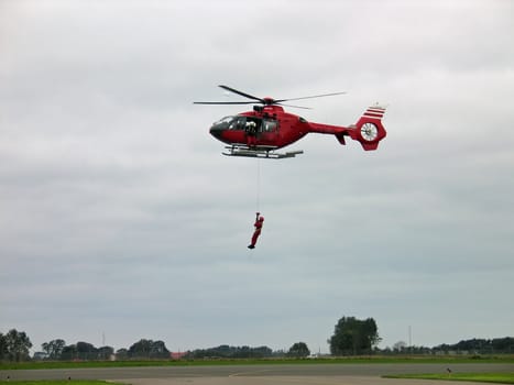 Rescue team member dropping down from a helicopter