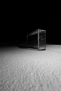 NIghtscene of a deserted soccerfield after a blizzard