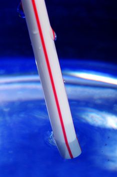 Close-up of drinking straw submerged - focus on submerged frontmost part of straw