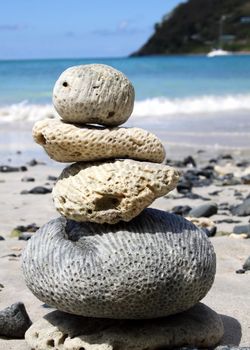 Coral pieces balance on each other at the beach.