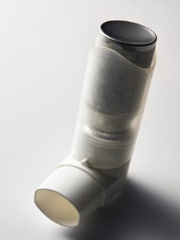 close up of the asthma inhaler on the plain background