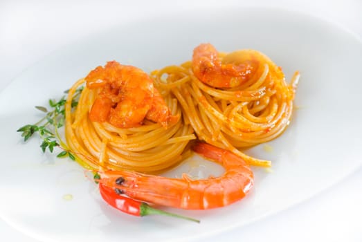 italian spaghetti pasta and fresh spicy shrimps sauce over white