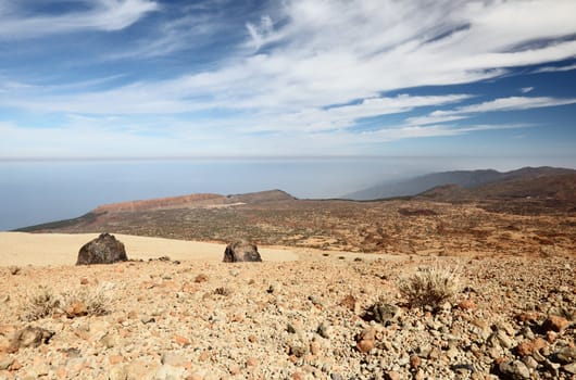 Tenerife - view from Teide and Monta�a Blanca within the national park of Teide on Tenerife. A  few of the big black Teide eggs are showing - Los Huevos del Teide. Blue sky for copy space.