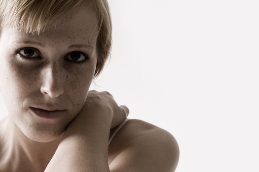 Studio portrait of a blond short haired girl looking sad