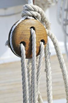 Close-up of a vintage boat: wooden block and ropes