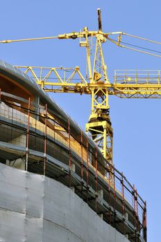 View of a new building with a yellow crane