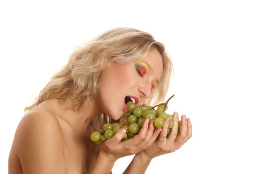 Young beautiful woman eating grapes isolated on white      