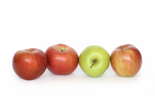 Few red and green apples lying in a row isolated on white background with clipping path