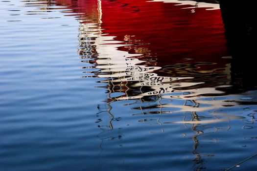 Abstract picture of a colored boat reflected in the water