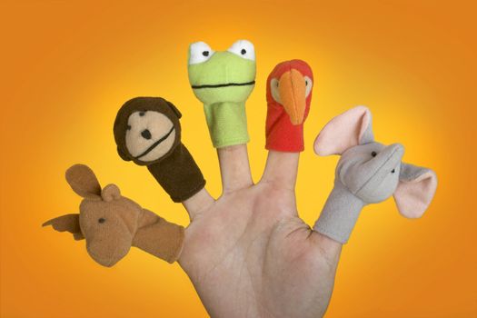 Female hand playing with puppets on the fingers