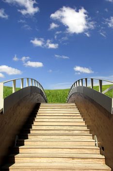 Wooden bridge ending in a beautiful green meadow