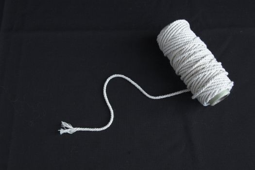 Roll of rope forming spiral on a black background