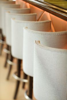 Stools lined up at bar.