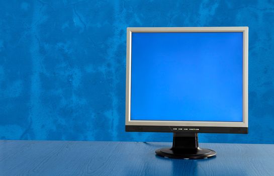 LCD display monitor on a blue room