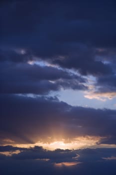 Sunbeams coming through clouds at sunrise over Maui, Hawaii, USA.