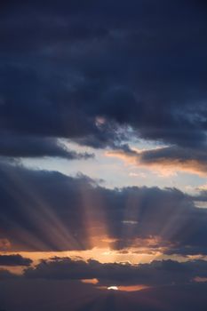 Sunbeams coming through clouds at sunrise over Maui, Hawaii, USA.