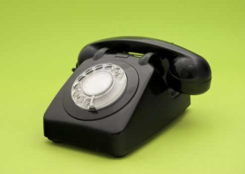 Vintage phone in a green background