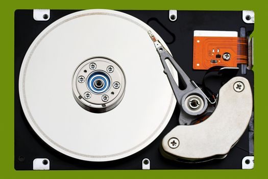 Open hard disk drive, in a green background
