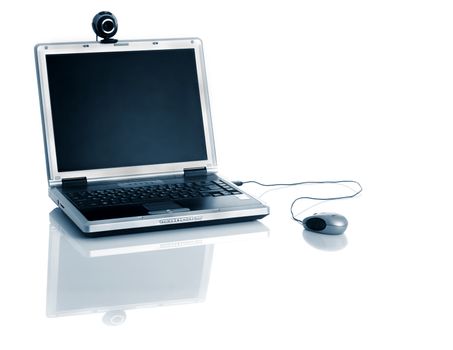 Laptop with a webcam over the table with reflection