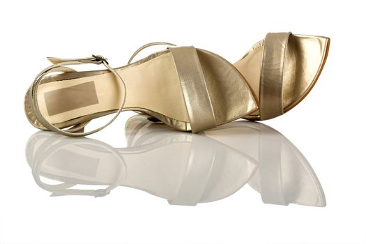 Beautiful feminine sandals on white with reflection