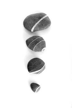 Four stones with diferent sizes isolated on a white background