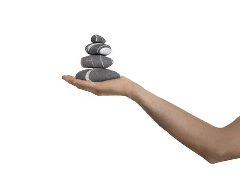 Small tower of balanced stones on man hand