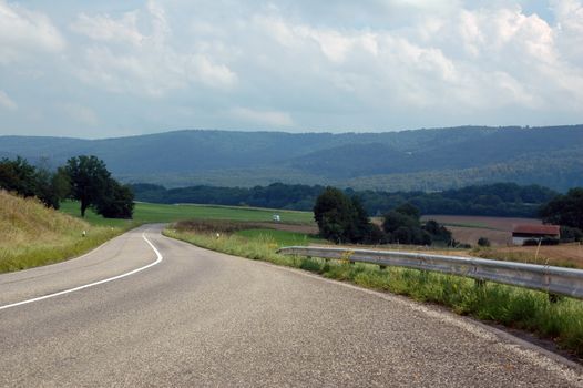 asphalt road in landscapes of porrentruy, switzerland