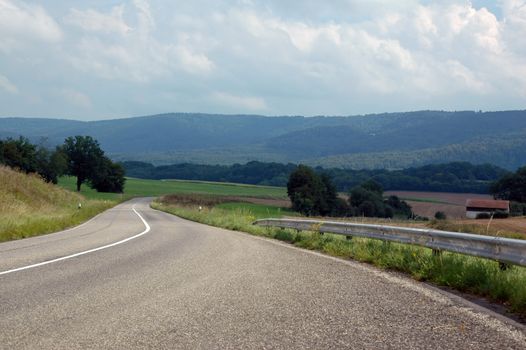 asphalt road in landscapes of porrentruy, switzerland