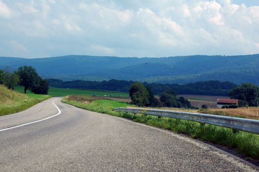 asphalt road in landscapes of porrentruy, switzerland