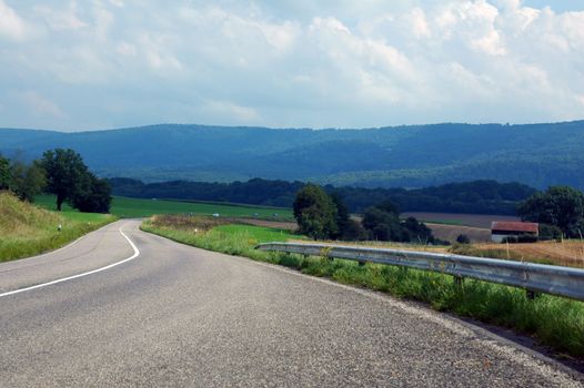 asphalt road in landscapes of porrentruy, switzerland