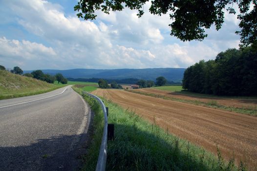 asphalt road in landscapes of porrentruy, switzerland