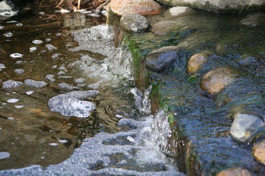 Close up of a waterfall in a garden.