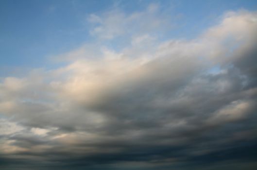 stormy weather at summer, dark clouds over blue sky