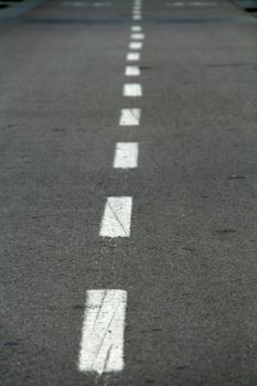 abstract image of a bicycle track, pavement with white lines