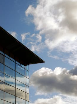 Exterior view of glass window building showing cloud reflections