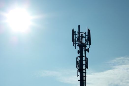 Silhouette of transmitter tower showing sunflare