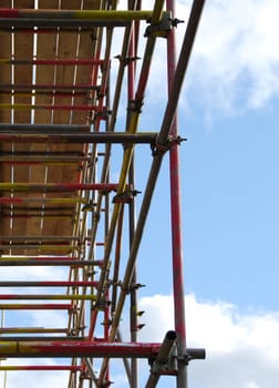 View of scaffolding tower against cloudy blue sky