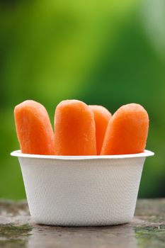 Organic peeled carrots in a recyclable bowl.