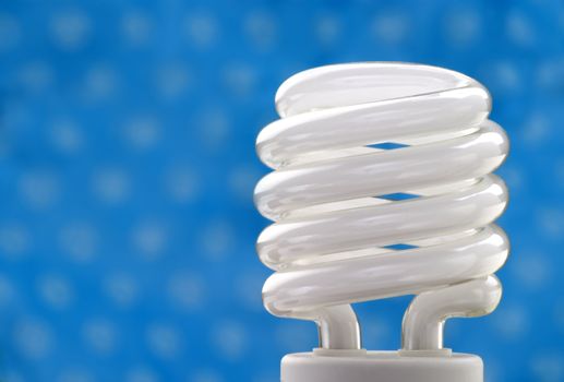 Compact fluorescent bulb with a blue background.