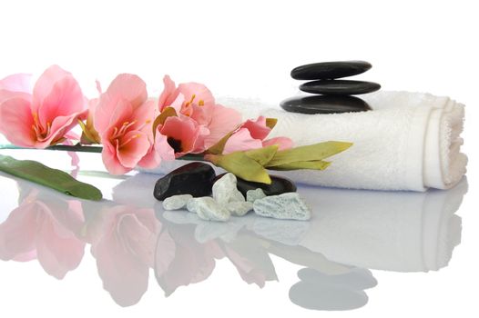 wellness zen and spa still life with flower towel and pebbles isolated on white