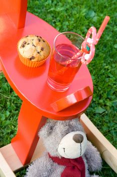 Muffin and juice with toys prepared for a snack.