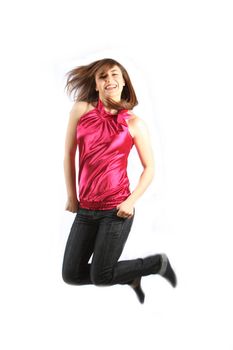 young woman jumps up to throw us back-legs against a white background with textile