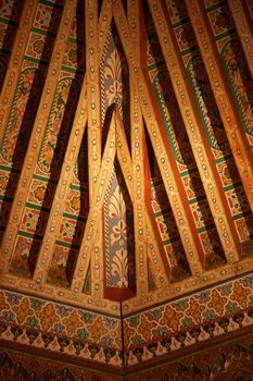 Fragment of a brightly lighted wooden ceiling in former islamic school